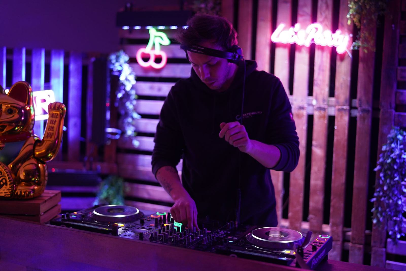 Milo Sava at the decks with the golden lucky cat