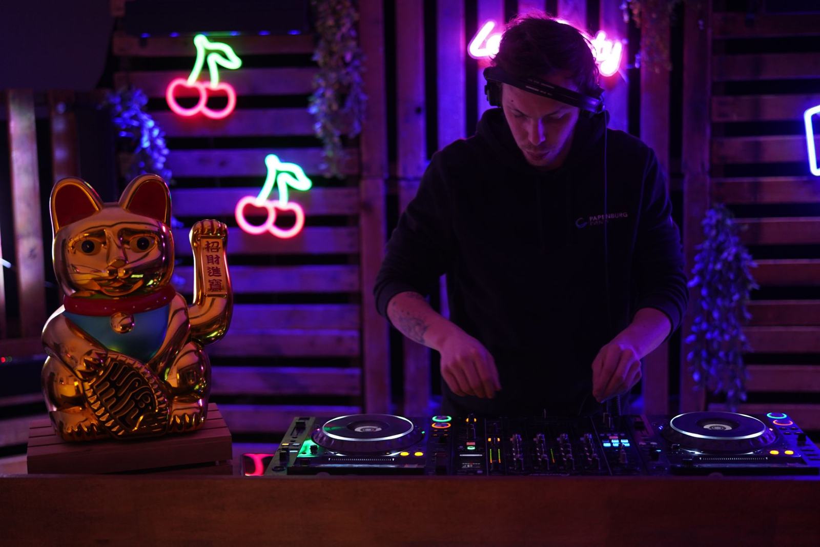 Wide shot of the booth with lucky cat and neon cherries